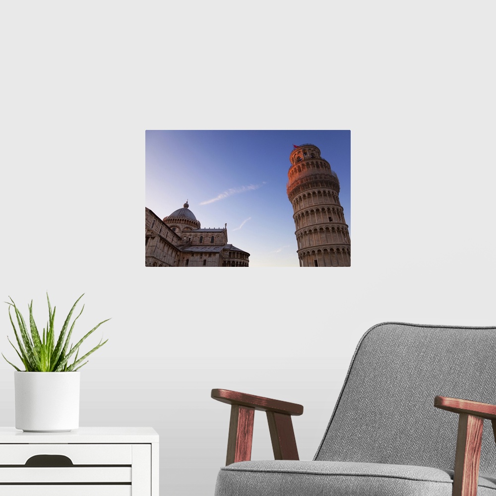A modern room featuring Sunlight on the top of the Leaning tower of Pisa at dusk, with the Duomo