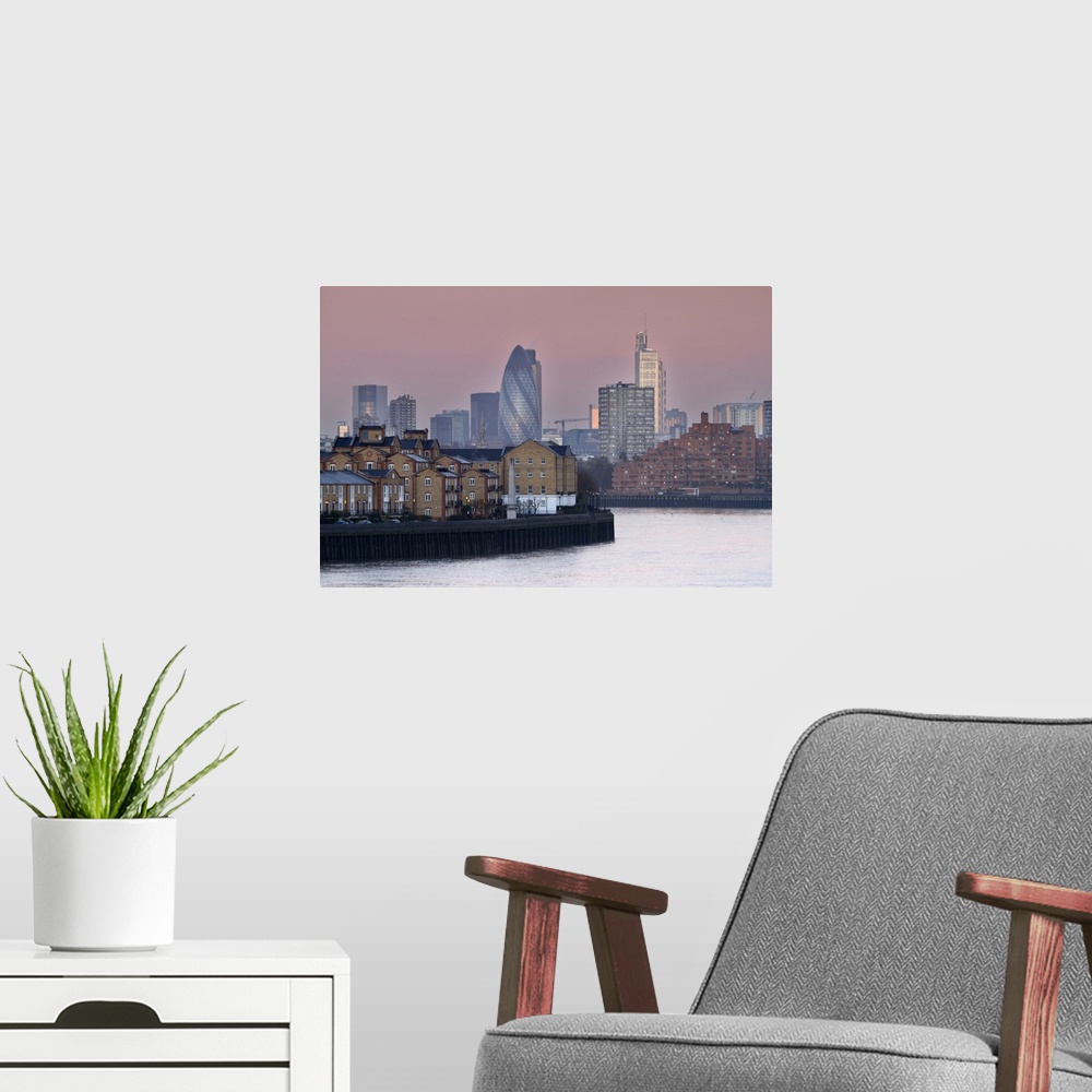 A modern room featuring Sunrise on River Thames towards City of London from Canary Wharf and Docklands.