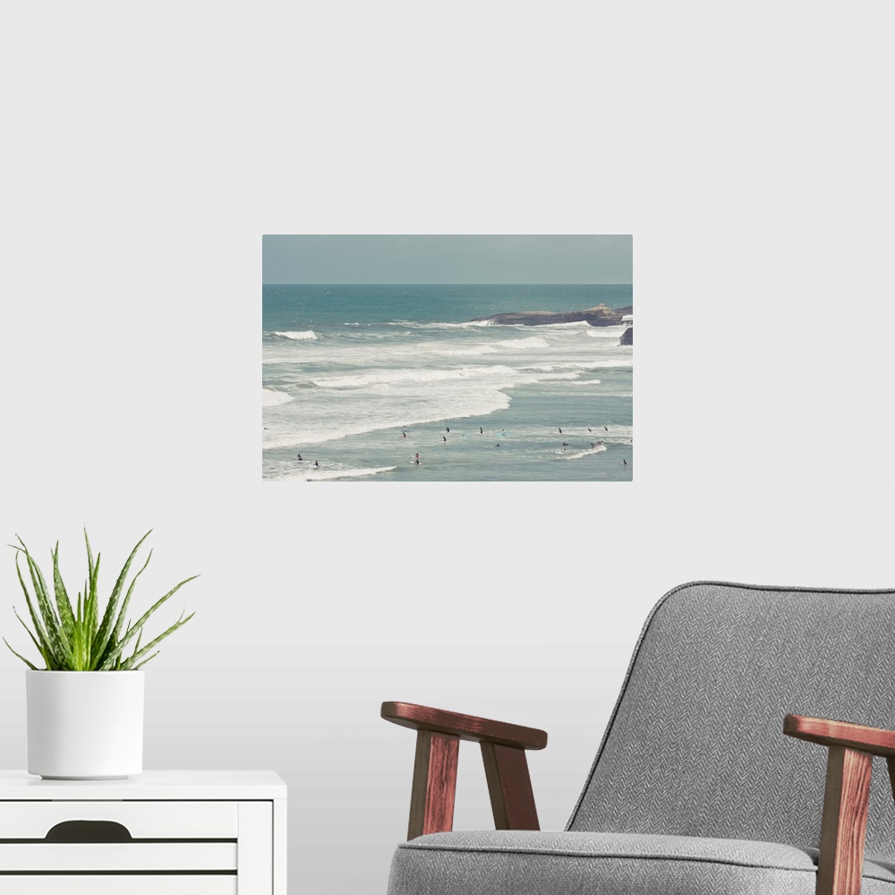 A modern room featuring Surfers lying in ocean.