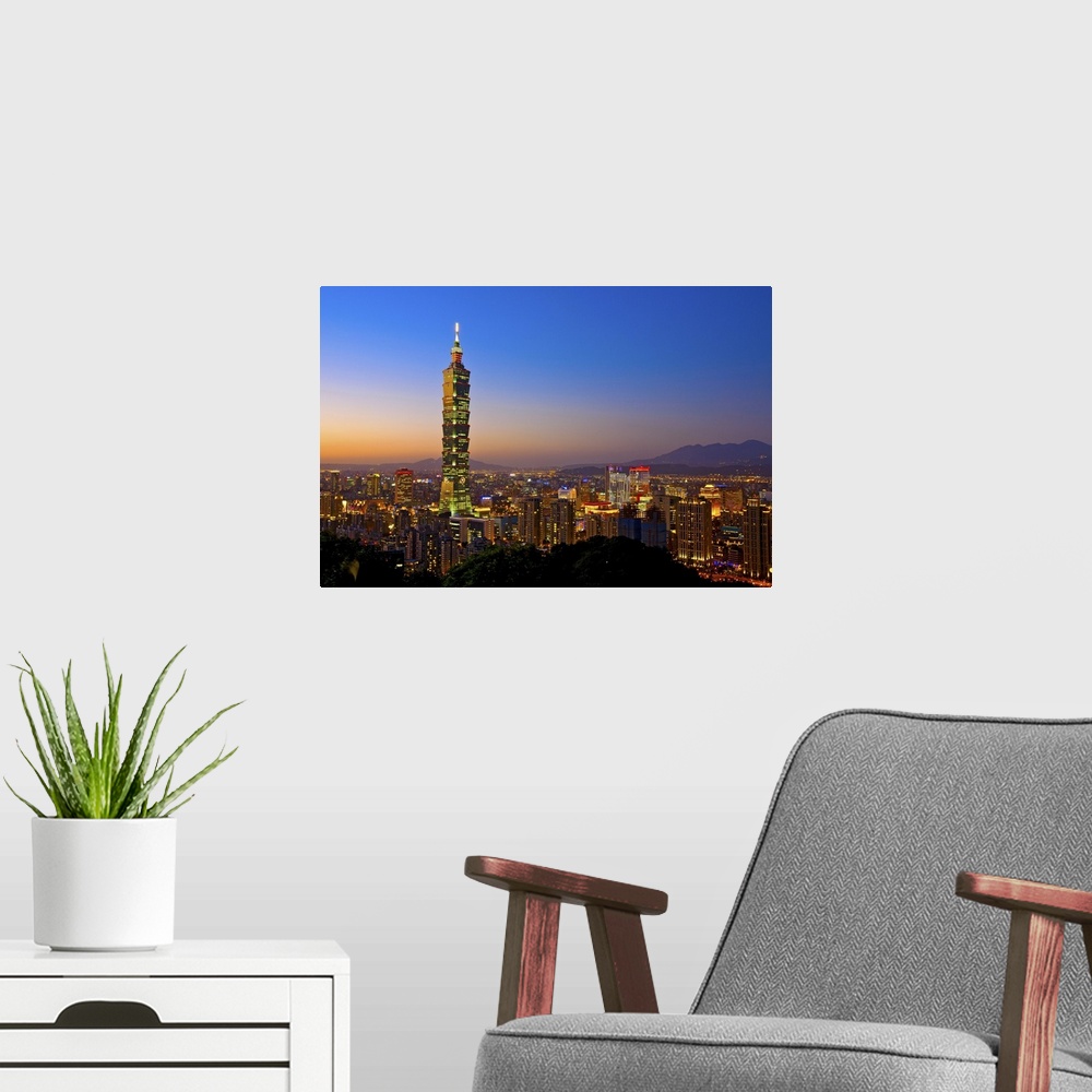 A modern room featuring Taipei 101 skyscraper with sunset Taipei Basin background.