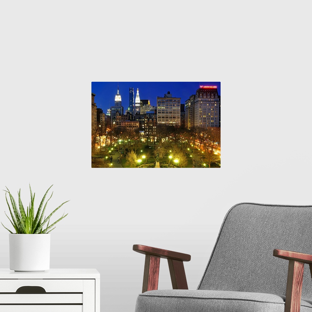 A modern room featuring Aerial view of Union Square in Manhattan, New York City at night.