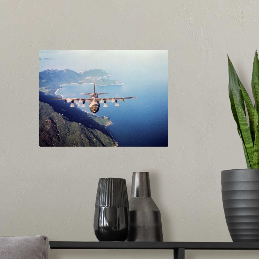 A modern room featuring Vietnam. a U.S. Airforce c-130 Hercules flies along the South Vietnamese coast on a cargo and pas...