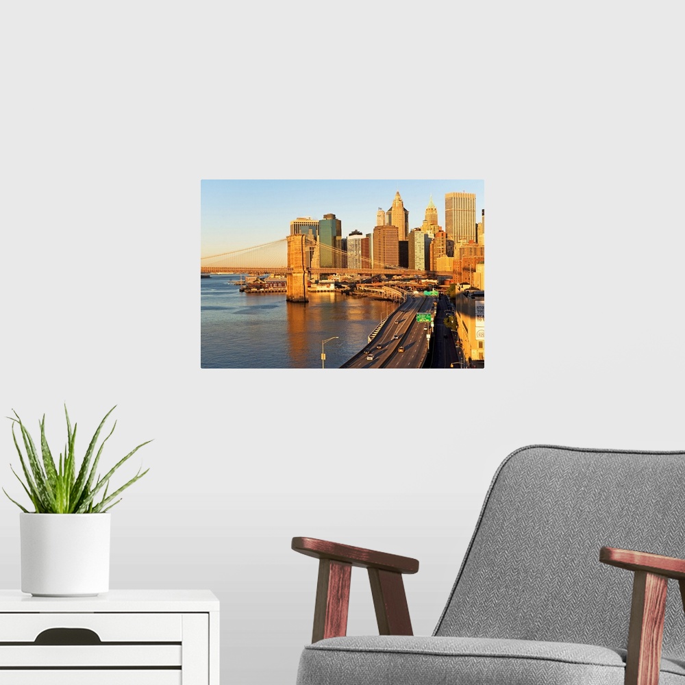 A modern room featuring A section of the New York City skyline is photographed with the Hudson river to the left and a br...