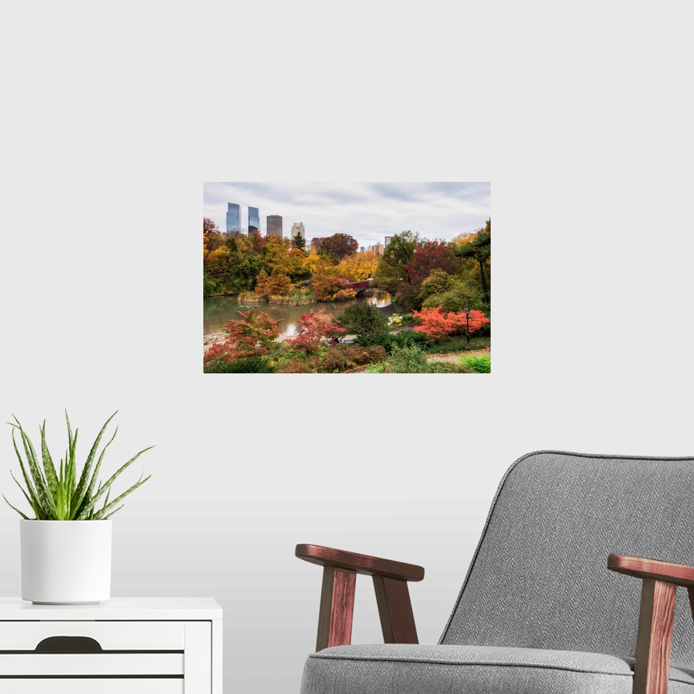 A modern room featuring View of the Central Park Pond and the New York skyline. The foliage is at peak color.