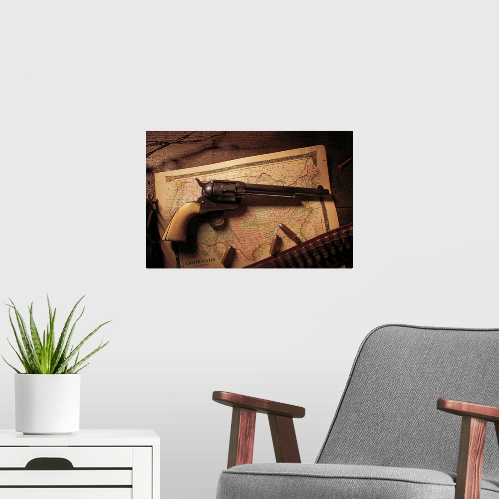 A modern room featuring Vintage revolver with bullets and map