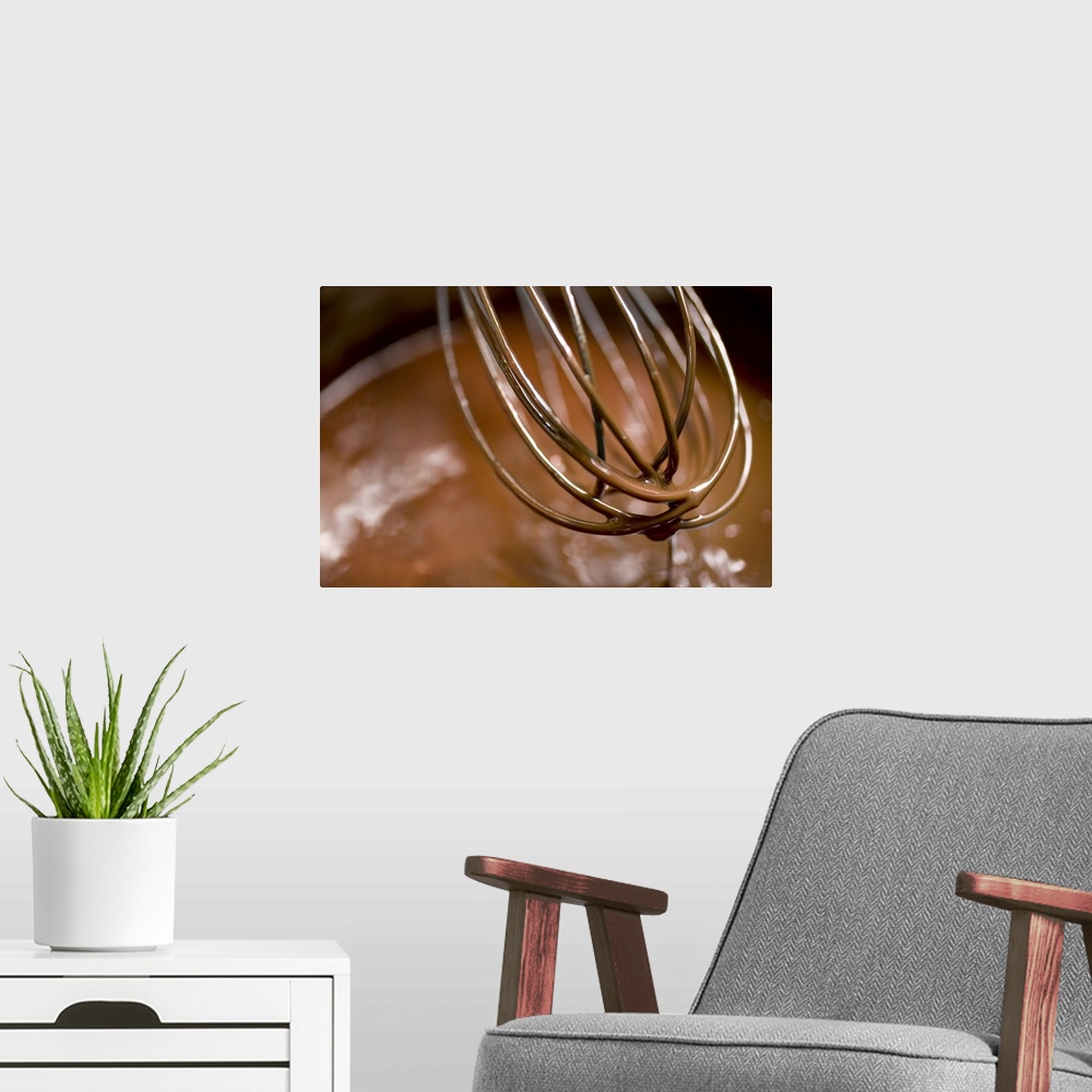 A modern room featuring Whisking the chocolate in a saucepan to melt the larger pieces