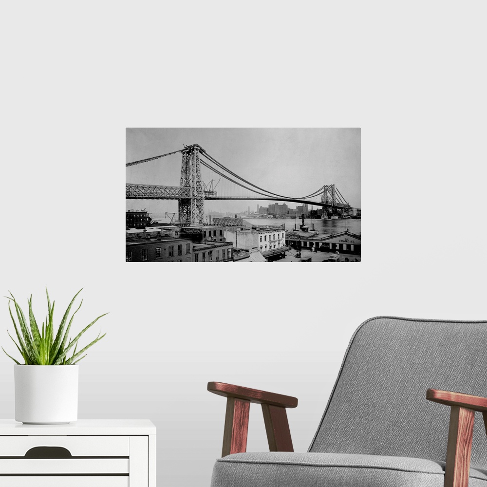 A modern room featuring The Williamsburg bridge extends from Delancy Street in the East Village across the East River to ...