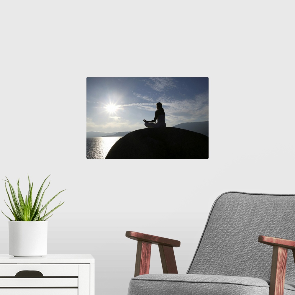 A modern room featuring Woman meditating on rock