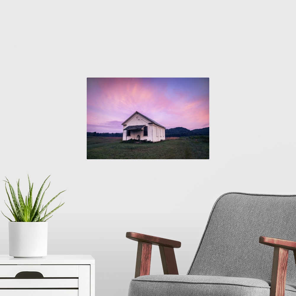 A modern room featuring Sunrise decorates the sky above an old church near Warren, Pennsylvania.