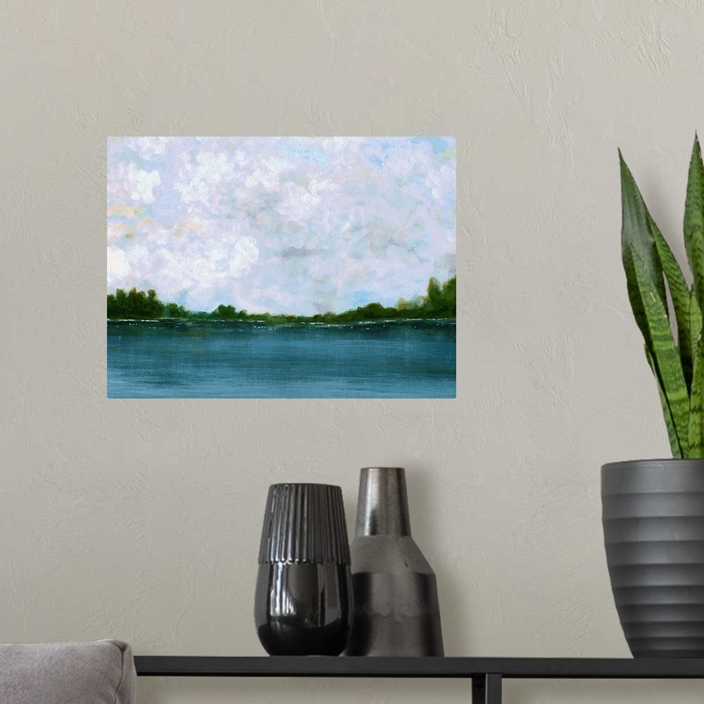 A modern room featuring Calm landscape painting with a peaceful lake lined with trees on the horizon and fluffy clouds in...