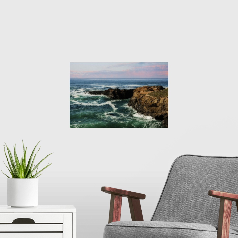 A modern room featuring A photograph of a seascape at sunset.