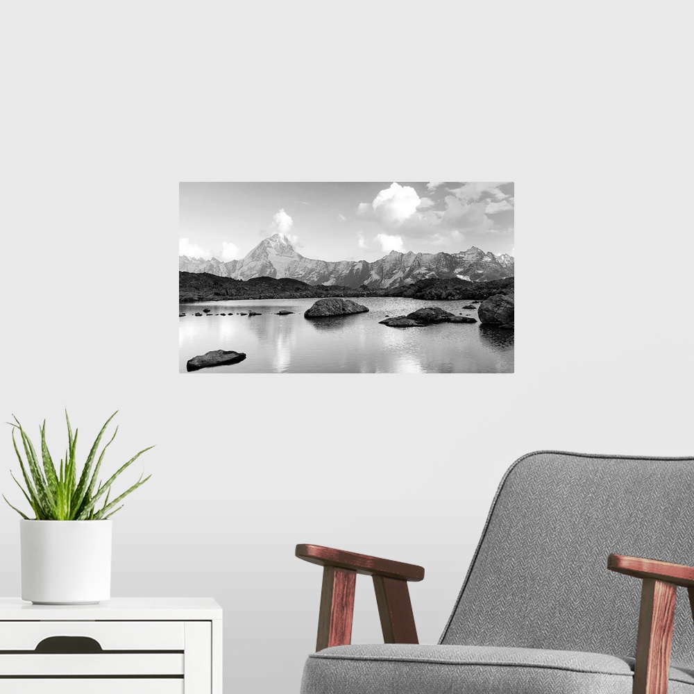 A modern room featuring Black and white landscape image of a lake with snow covered mountains in the background.