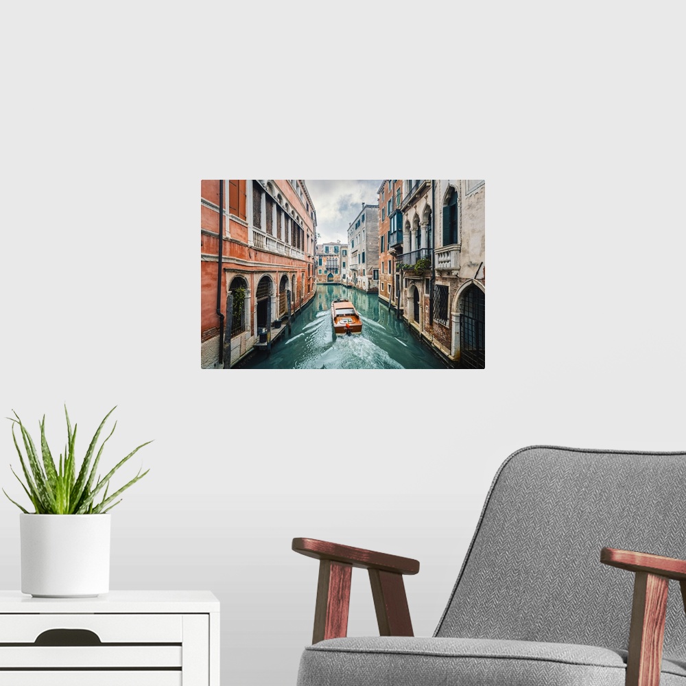 A modern room featuring A boat cruising a green canal in Venice, Veneto, Italy