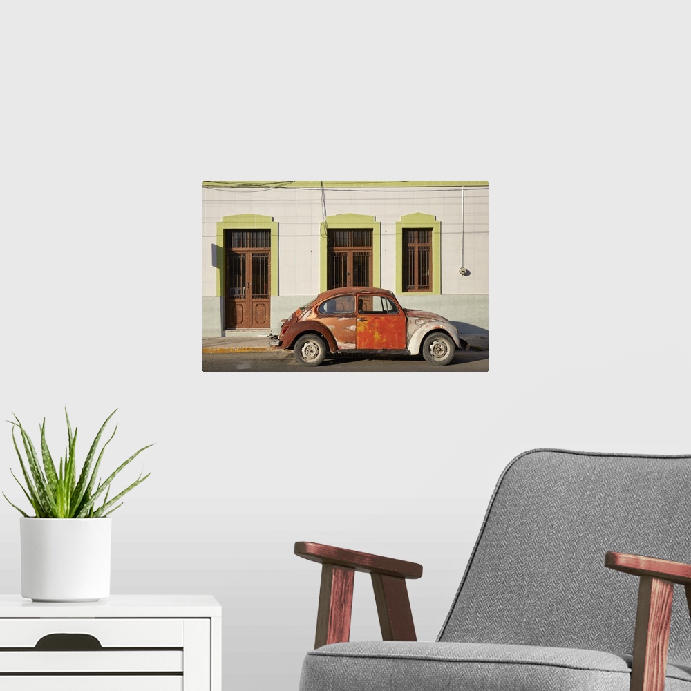 A modern room featuring A vintage Volkswagen Beetle in front of a house in Merida, Yucatan, Mexico.