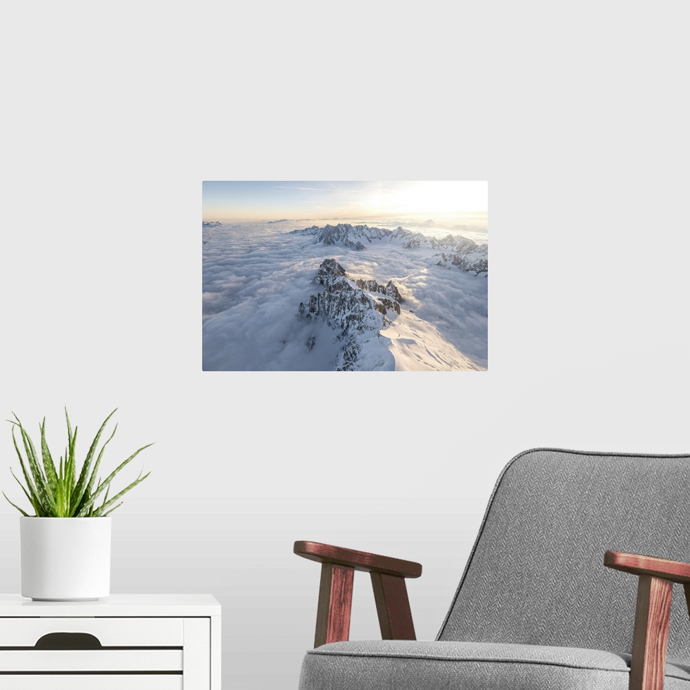 A modern room featuring Aerial view of snowy peaks of Mont Blanc during sunrise, Courmayeur, Aosta Valley, Italy, Europe....