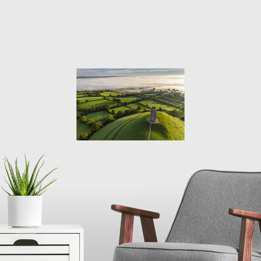 A modern room featuring Aerial view of St. Michael's Tower on Glastonbury Tor on a misty autumn morning, Somerset, Englan...