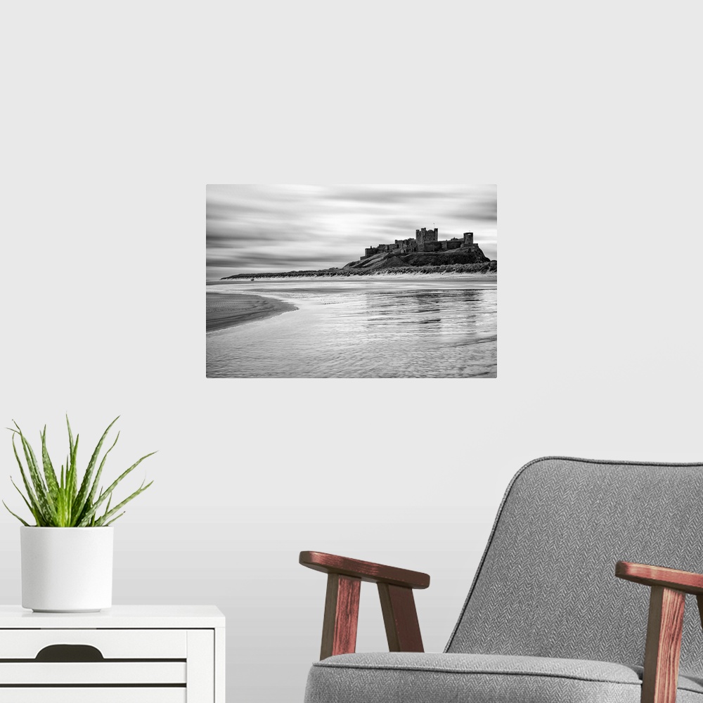 A modern room featuring Bamburgh castle and beach at low tide, Northumberland, UK