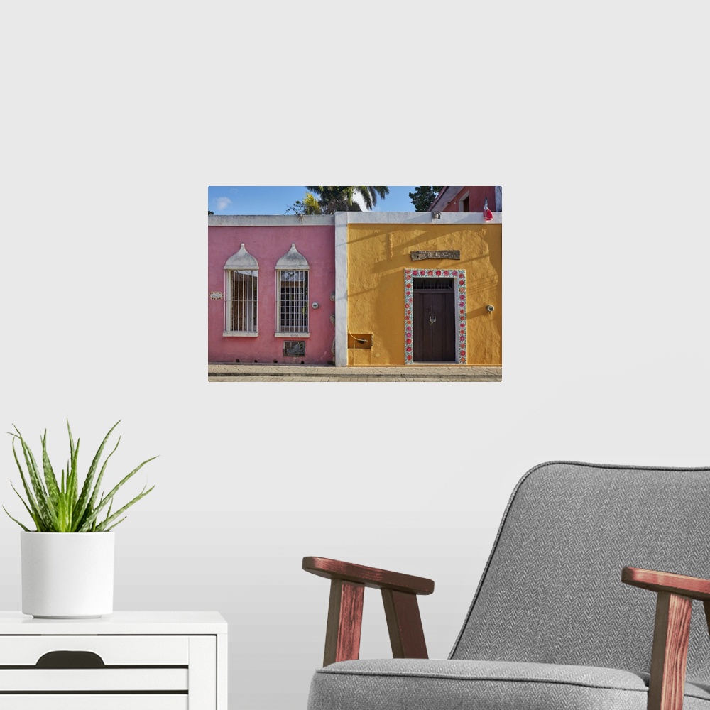 A modern room featuring Colorful colonial houses on the "Calzada de los Frailes" street, Valladolid, Yucatan, Mexico.