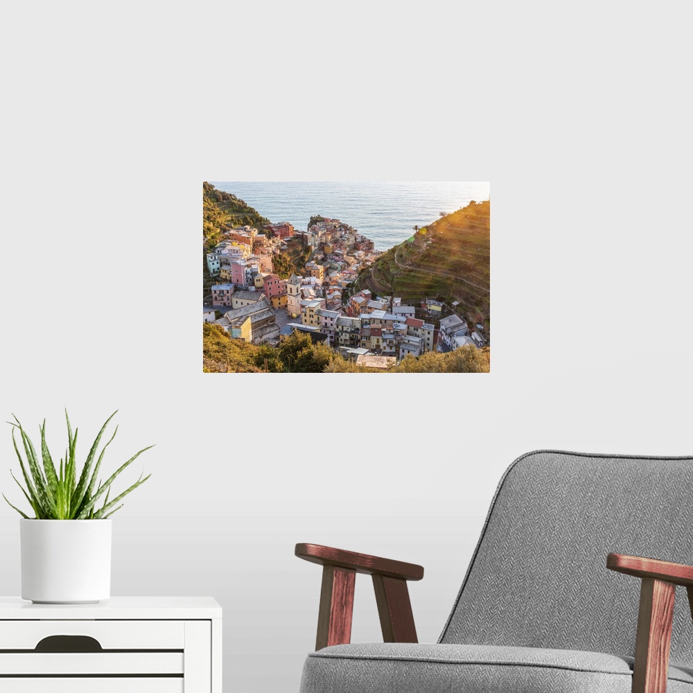 A modern room featuring Europe, Italy, Liguria. View over the Cinque Terre village Manarola at sunset