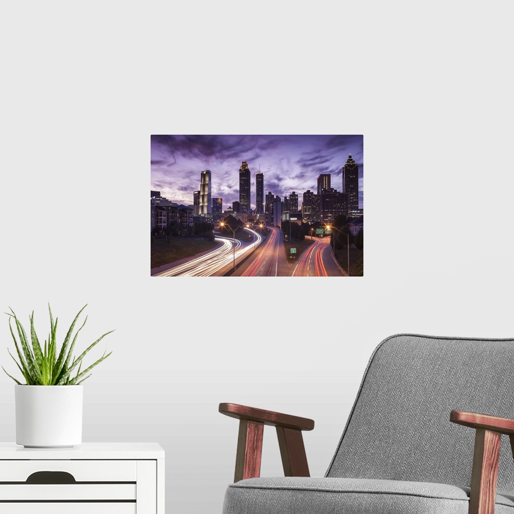 A modern room featuring USA, Georgia, Atlanta, city skyline from Interstate 20, dusk