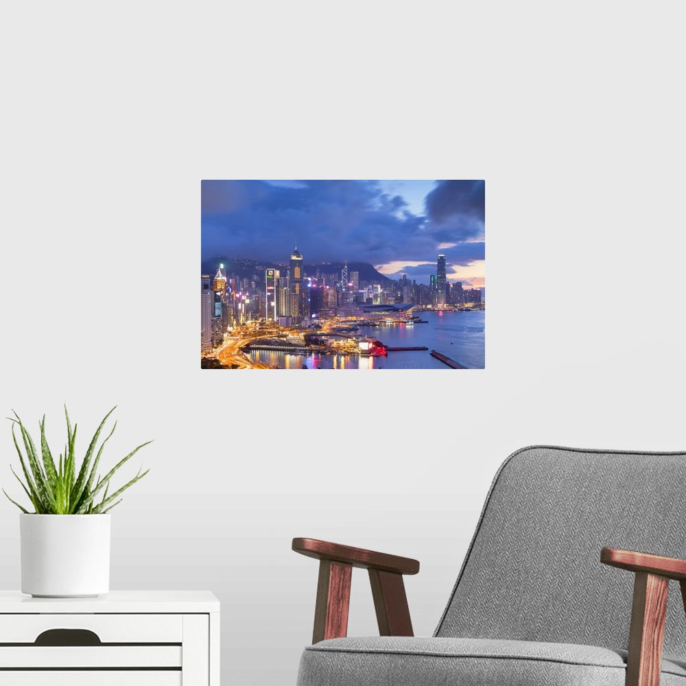 A modern room featuring Hong Kong Island skyline at sunset, Hong Kong.