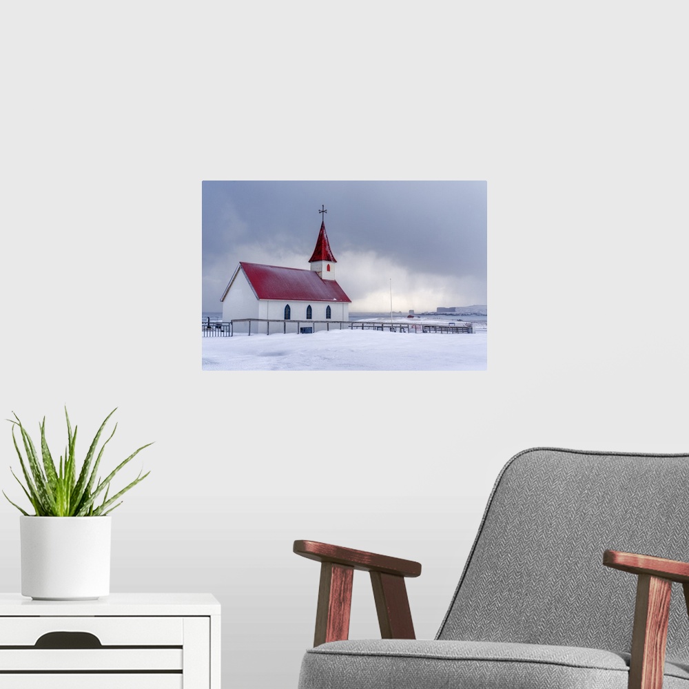 A modern room featuring Iceland: the little church of Reynisfjara looking at the storm on the seashore