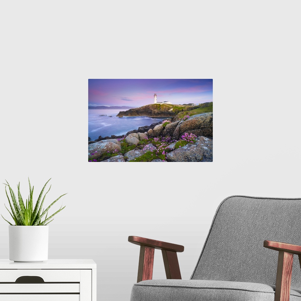 A modern room featuring Ireland, Co. Donegal, Fanad, Fanad lighthouse with Sea thrift in foreground at dusk.
