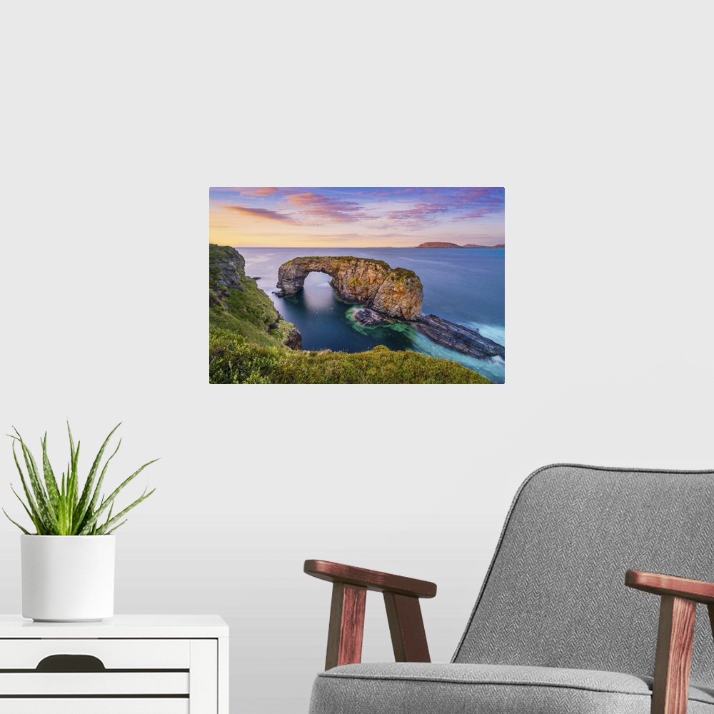 A modern room featuring Ireland, Co.Donegal, Fanad, Great Pollet sea arch at dusk