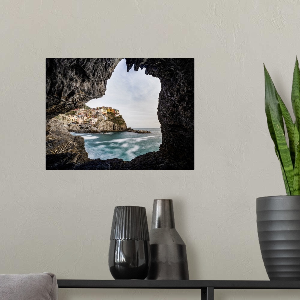 A modern room featuring Italy, Liguria: Manarola from a cave on the shore.