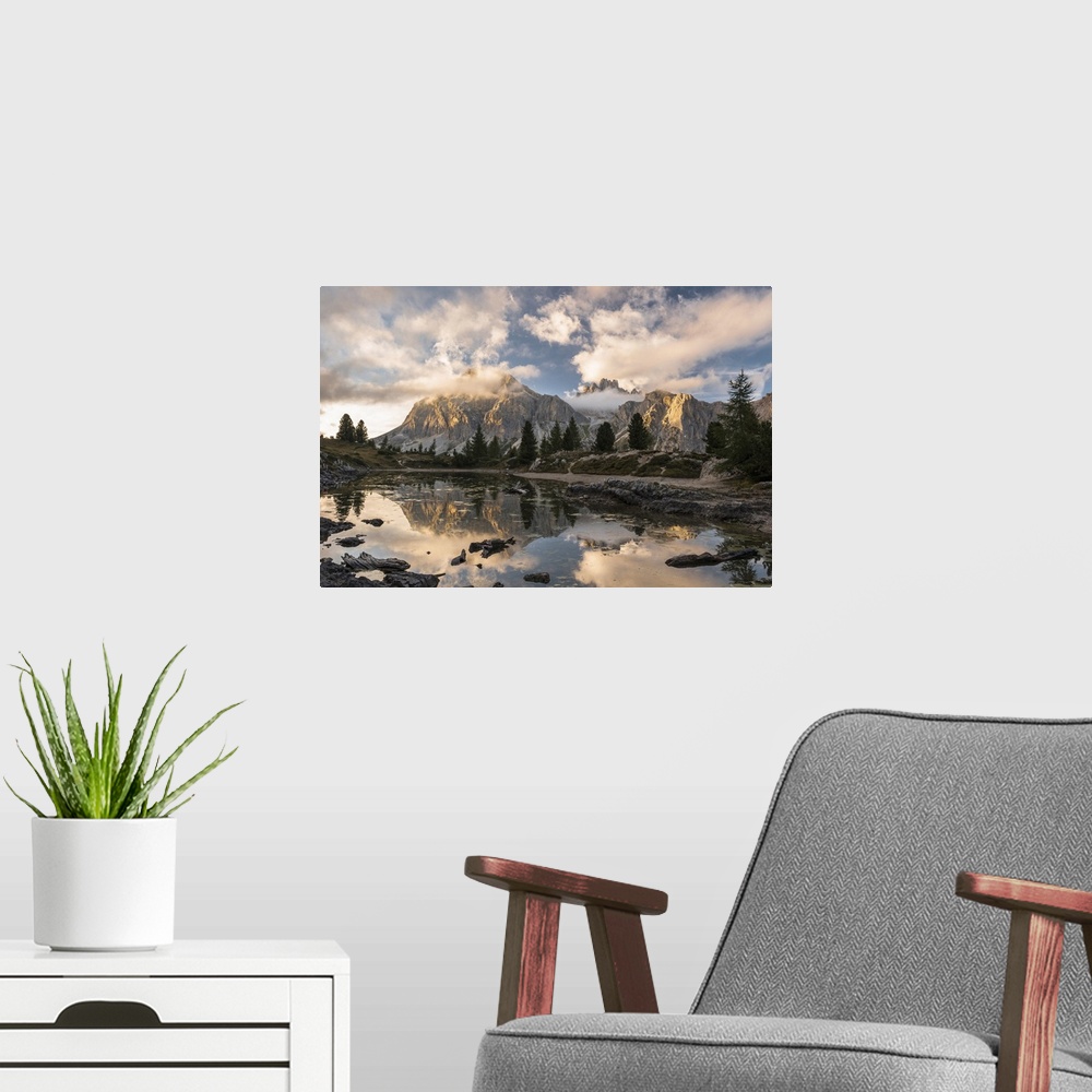 A modern room featuring Limides Lake at sunset with Lagazuoi on the background. Belluno, Veneto, Italy.