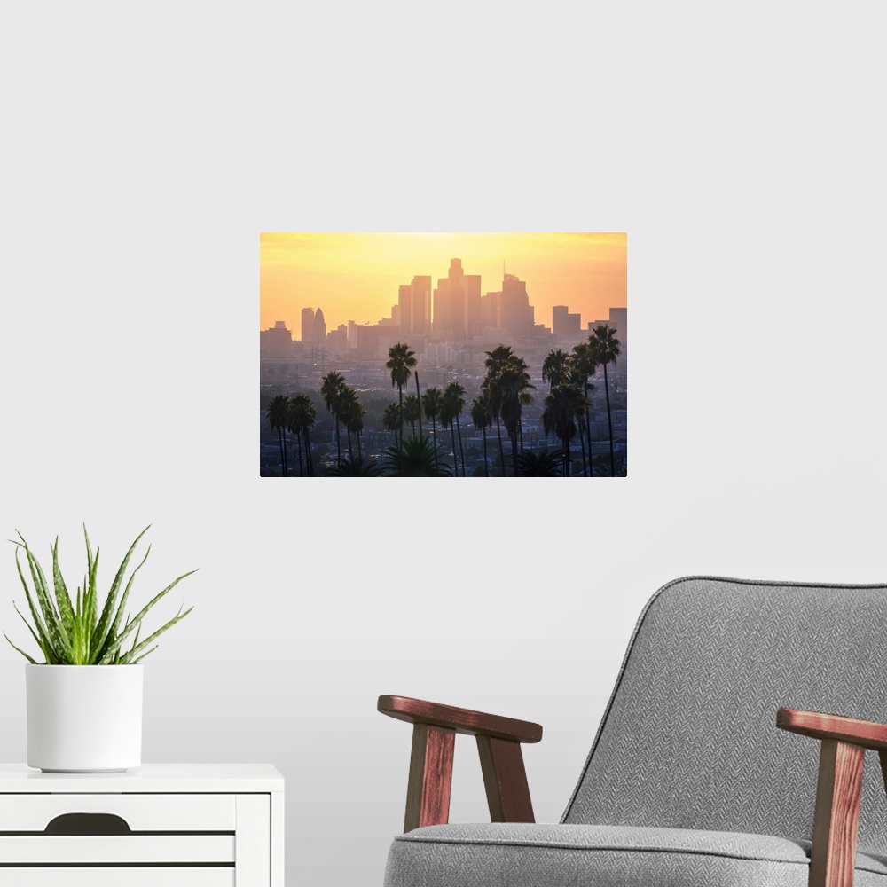 A modern room featuring Los Angeles Downtown and palm trees at sunset. This is a classic view of the city of angels, with...