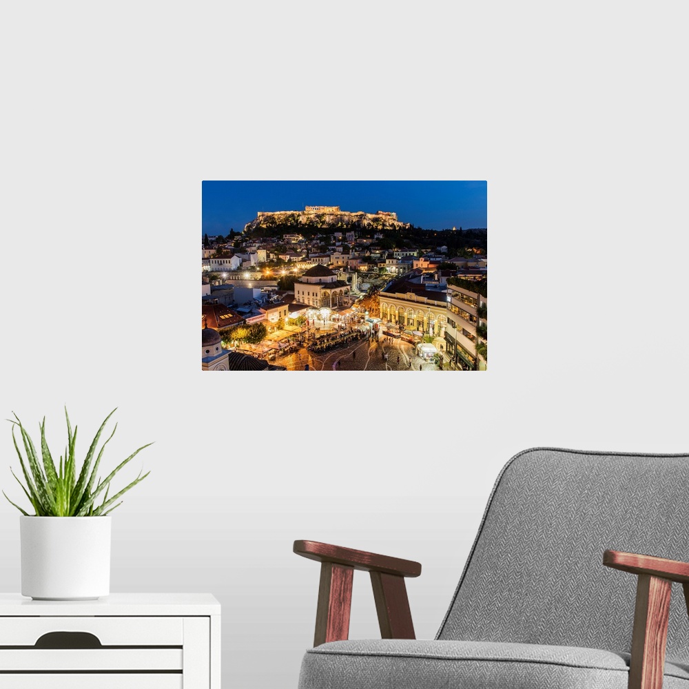A modern room featuring Night city skyline with Monastiraki square and Acropolis in the background, Athens, Attica, Greece