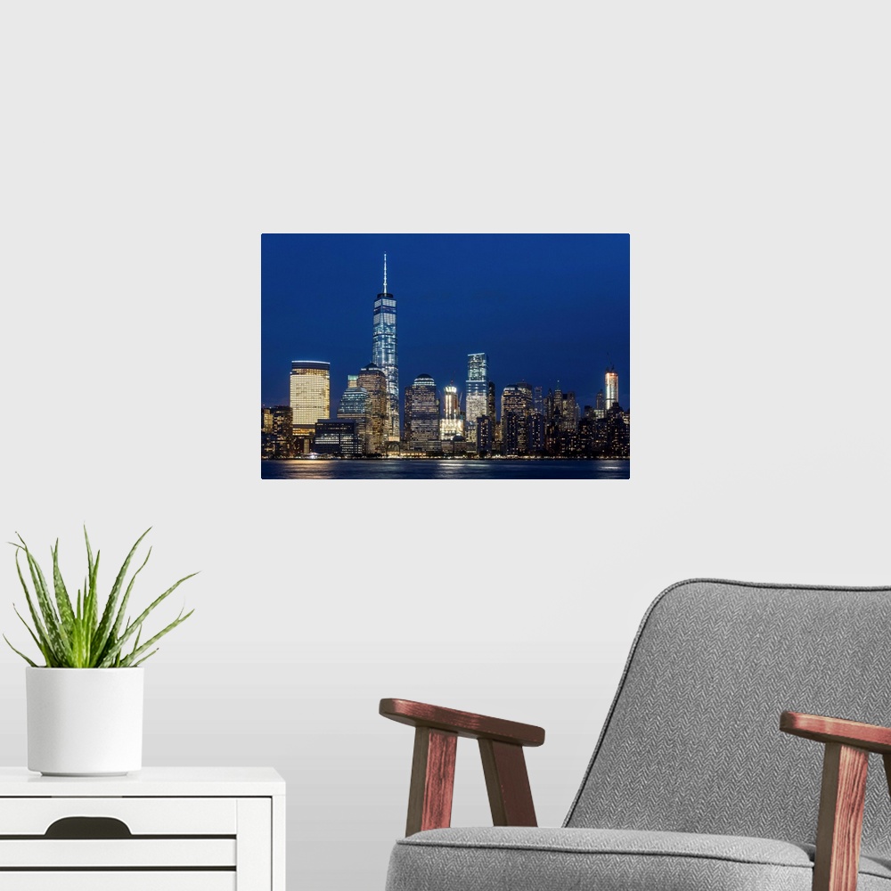 A modern room featuring Night view of One World Trade Center and Lower Manhattan financial center, Manhattan, New York, USA.