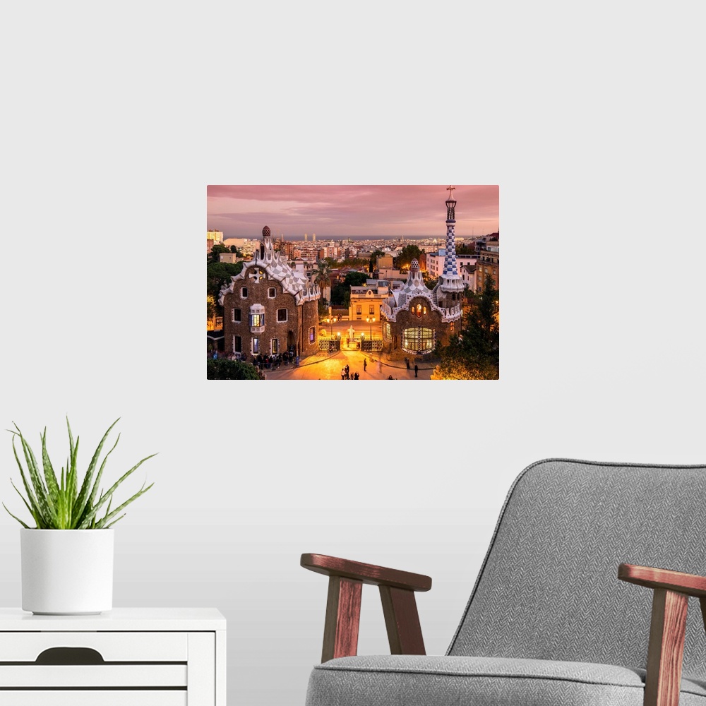 A modern room featuring Park Guell with city skyline behind at dusk, Barcelona, Catalonia, Spain.