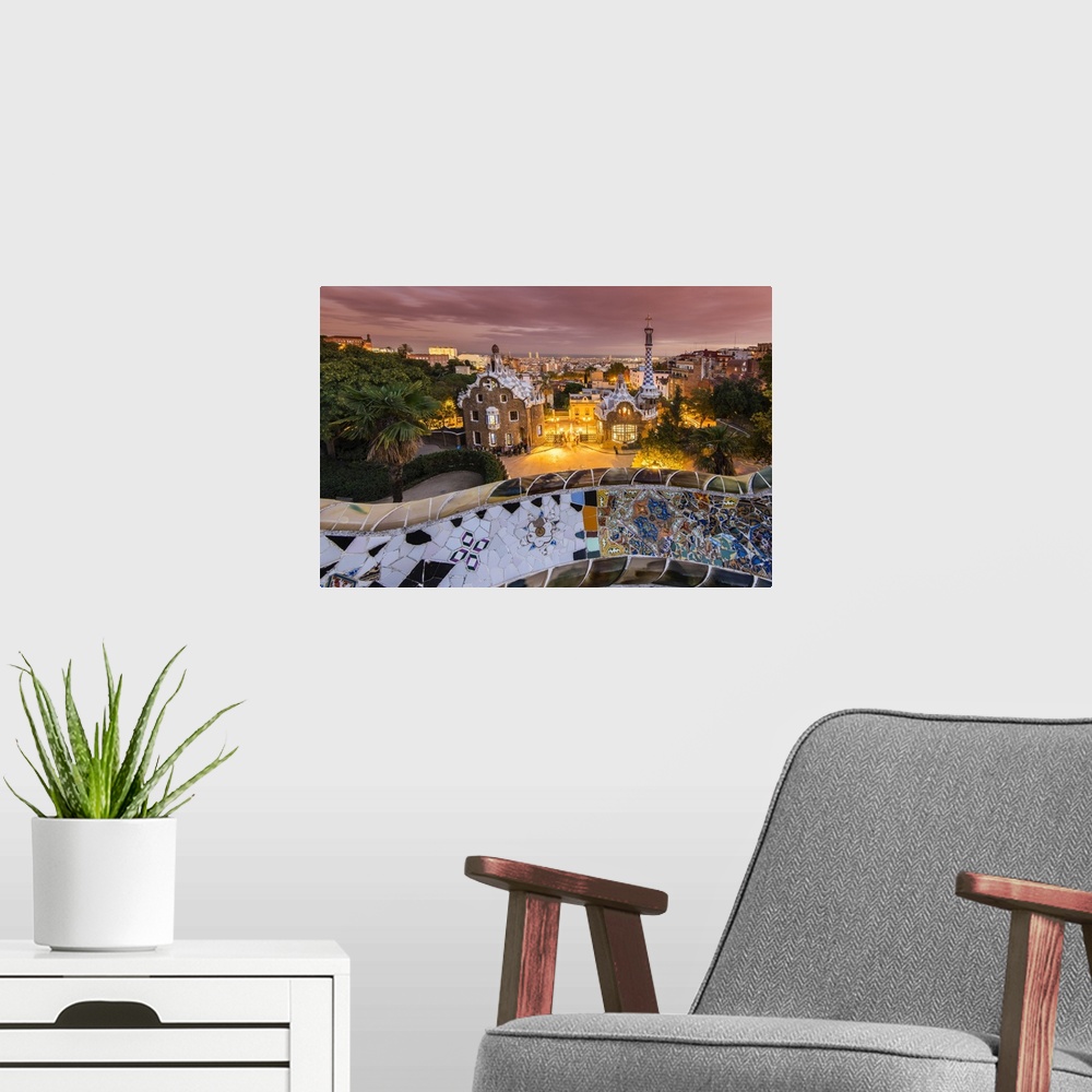 A modern room featuring Park Guell with city skyline behind at dusk, Barcelona, Catalonia, Spain.