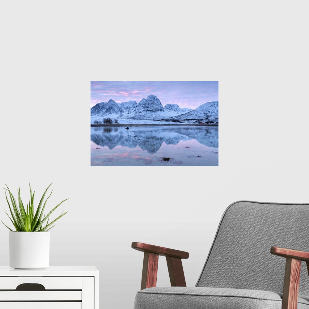 A modern room featuring Rakeltinden is reflected in the fjord. Storsteinnes, Balsfjorden, Lyngen Alps, Troms, Norway, Lap...