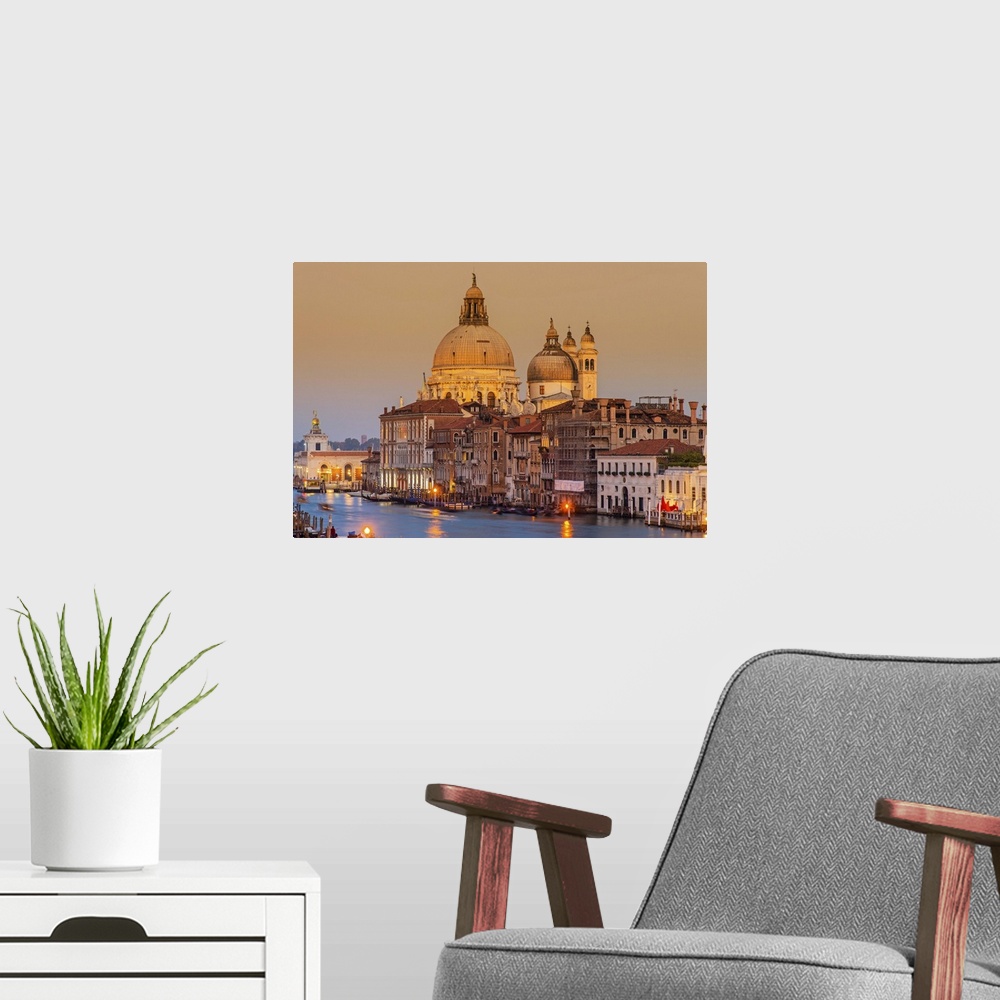 A modern room featuring Santa Maria della Salute church and Grand Canal at sunset, Venice, Veneto, Italy