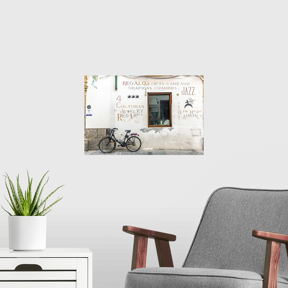 A modern room featuring Spain, Andalusia, Cordoba. Bicycle against a wall in the old town