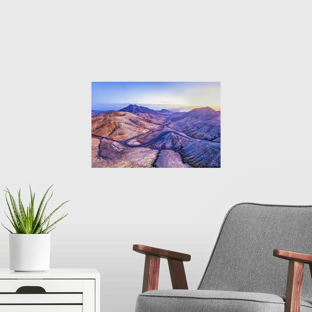 A modern room featuring Spain, Canary Islands, Fuerteventura, mountain road crossing the volcanic landscape near Sicasumb...
