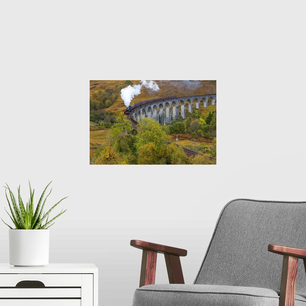 A modern room featuring Jacobite steam train crossing Glenfinnan viaduct, Lochaber, nr Fort William, Highlands, Scotland, UK
