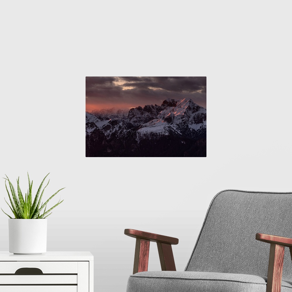 A modern room featuring Sunset on the top of Dolada Mount, in Alpago mountain range, Italy