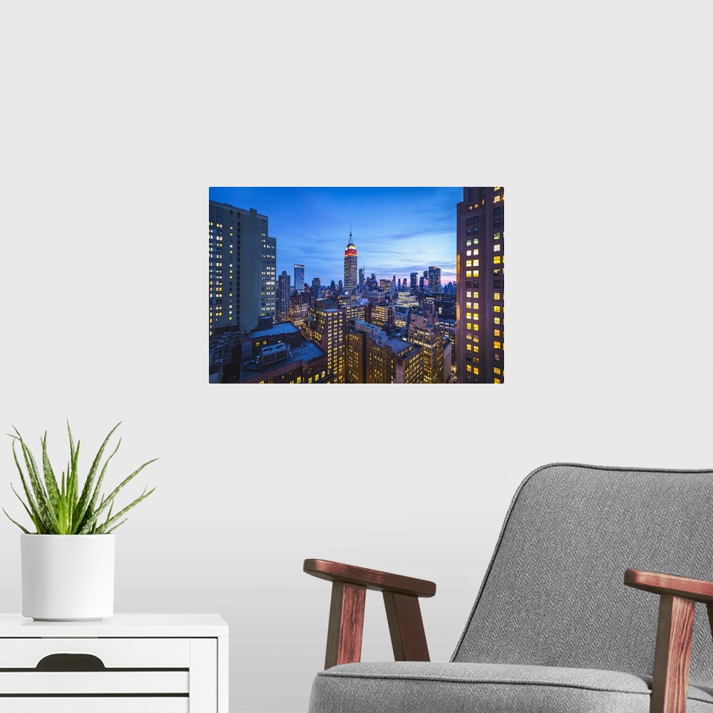 A modern room featuring The Empire State Buiklding at evening. Manhattan, New York, USA