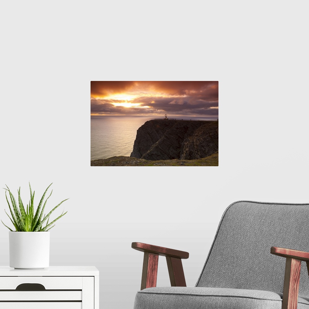 A modern room featuring The Midnight Sun breaks through the clouds at Nordkapp, Finnmark, Norway