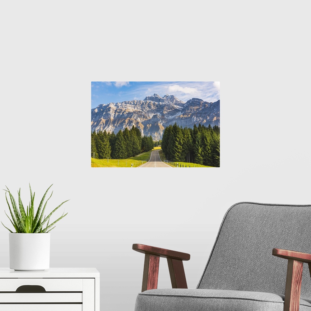 A modern room featuring The road leading to Schwagalp pass with mount Santis in the background, Switzerland.