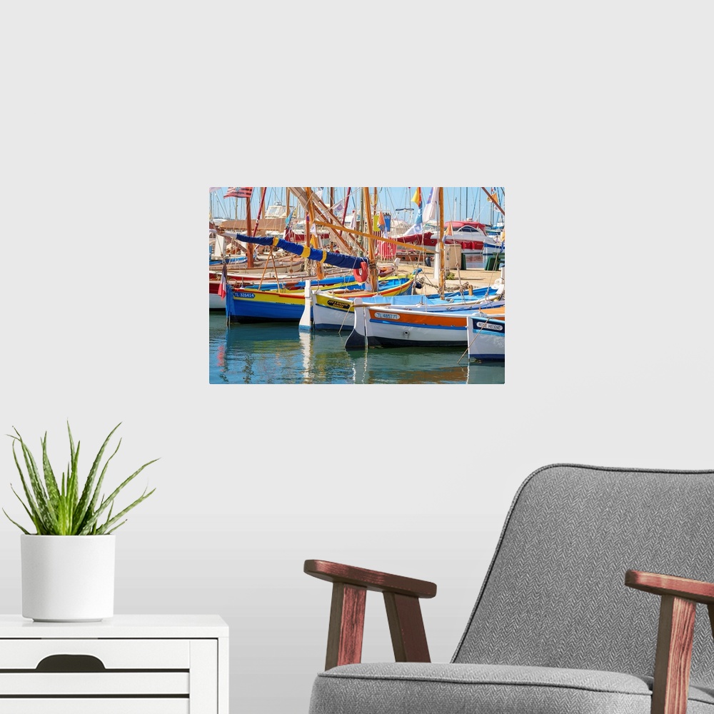A modern room featuring Traditional colorful wooden fishing boat in the port harbor at Sanary-sur-Mer, Var department, Pr...