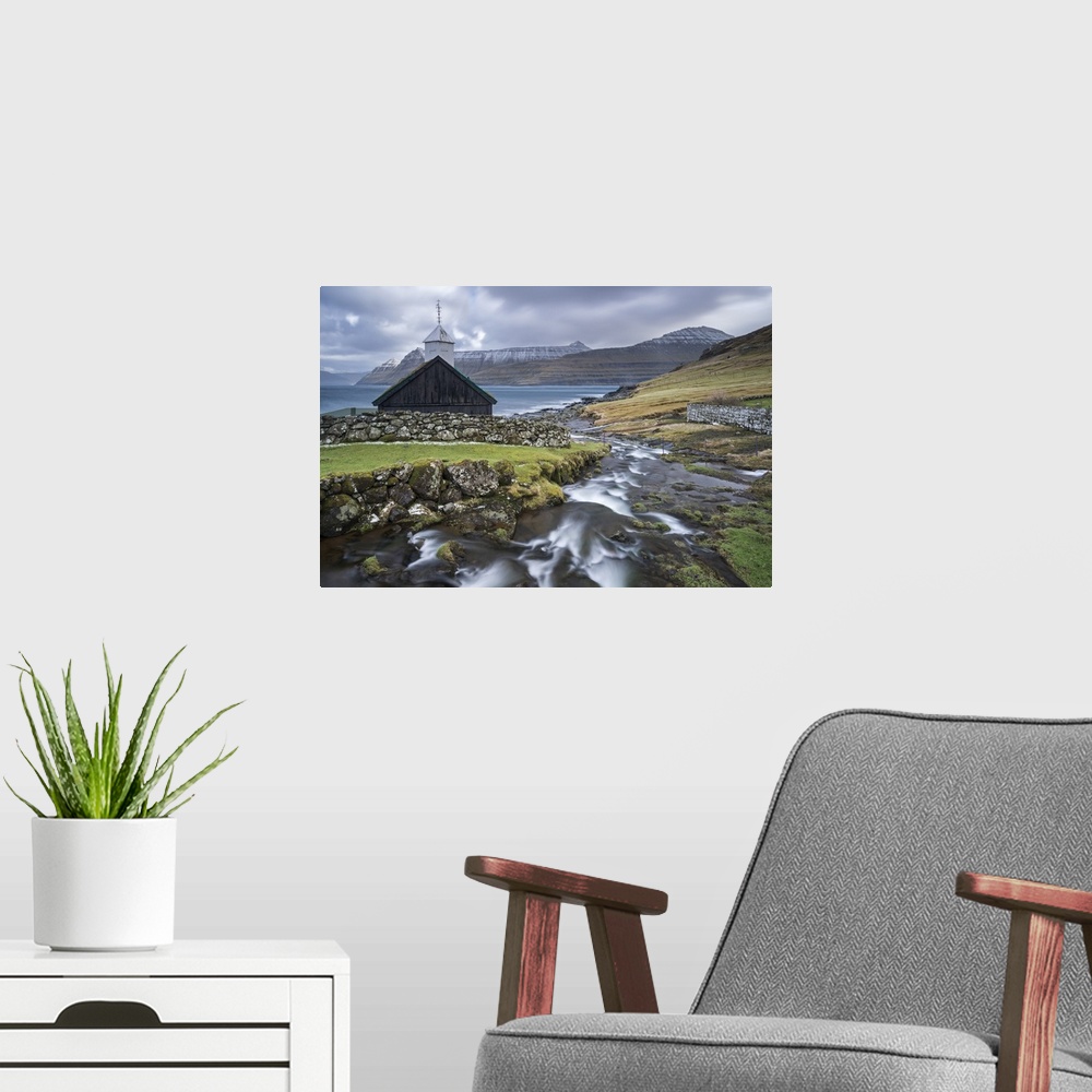A modern room featuring Traditional Faroese wooden turf roofed church in the village of Funningur on the island of Eystur...