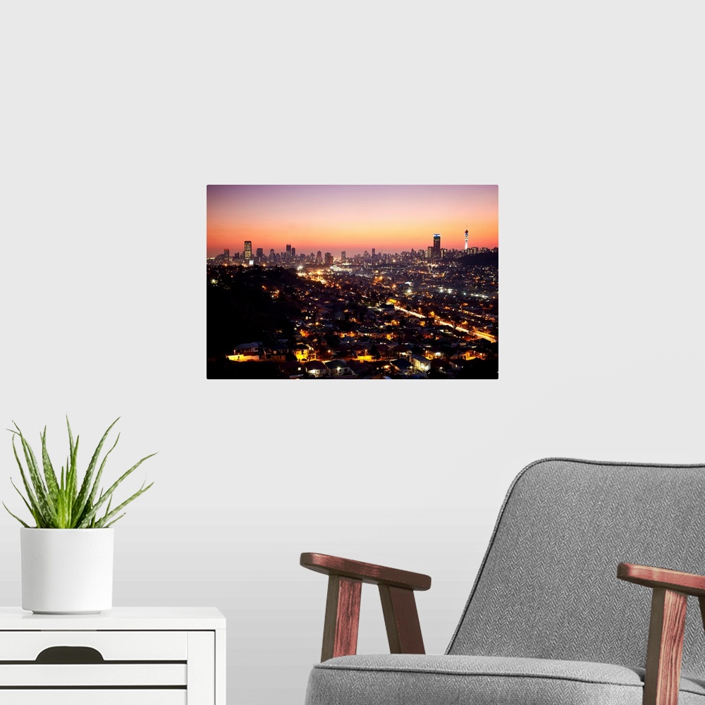 A modern room featuring View of Johannesburg skyline at sunset, Gauteng, South Africa
