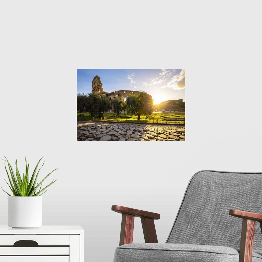 A modern room featuring View of the Colosseum during a winter sunrise from the Via Sacra. Rome, Lazio, Italy.