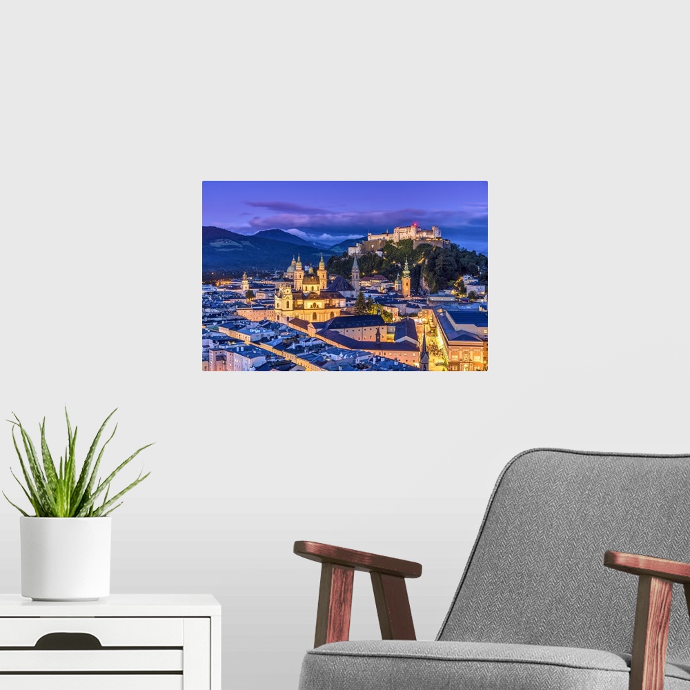 A modern room featuring View over the old town and Hohensalzburg Castle at dusk, Salzburg, Austria
