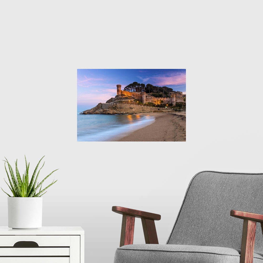 A modern room featuring View at dusk of Vila Vella, the medieval old town of Tossa del Mar, Costa Brava, Catalonia, Spain